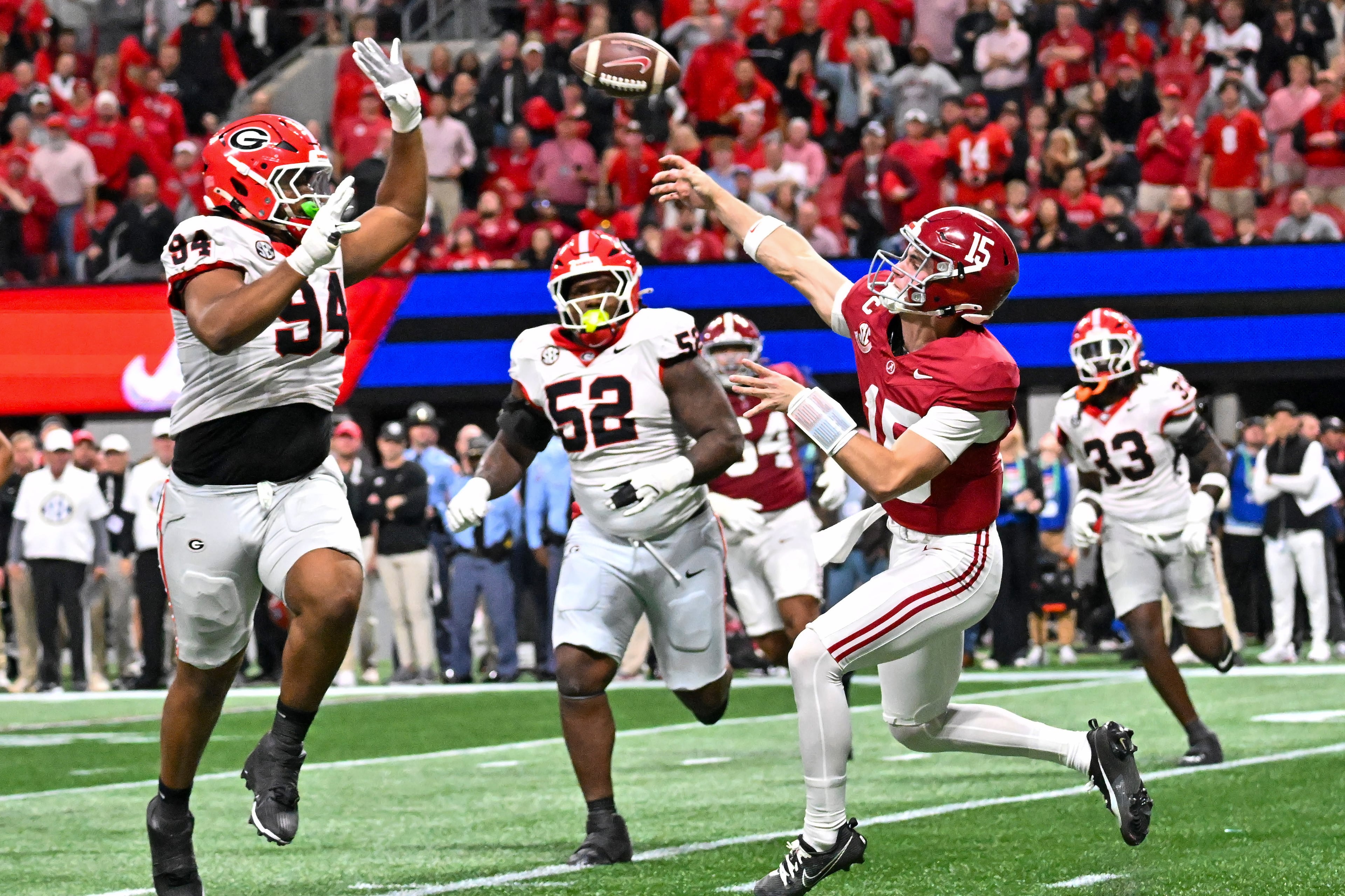 Alabama quarterback Ty Simpson (15) throws under pressure from the Georgia defense during the third quarter of the SEC Championship game at Mercedes-Benz Stadium, Saturday, Dec. 6, 2025, in Atlanta. (Hyosub Shin / AJC)