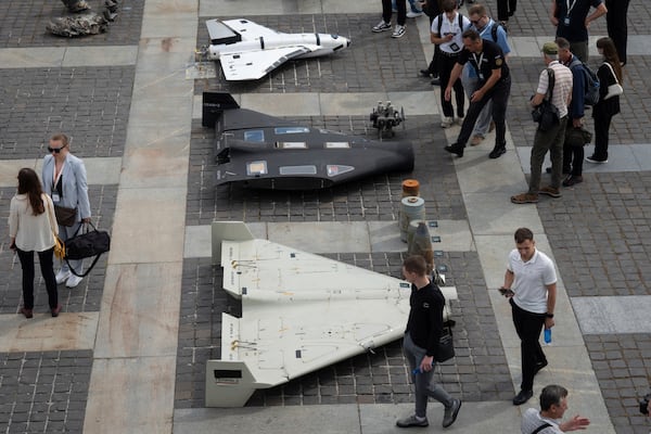 Visitors watch damaged Russian drones during the International Conference on Expanding Sanctions Against Russia in Kyiv, Ukraine, Friday, June 27, 2025. (AP Photo/Efrem Lukatsky)