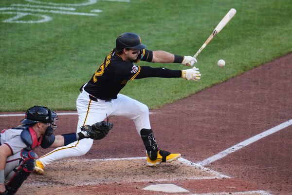 Pittsburgh Pirates' Matt Gorski singles off Atlanta Braves pitcher Daysbel Hernández, driving in a run, during the eighth inning of a baseball game in Pittsburgh, Saturday, May 10, 2025. (AP Photo/Gene J. Puskar)