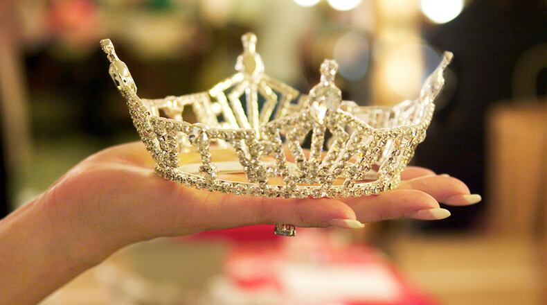 Close up of woman holding tiara