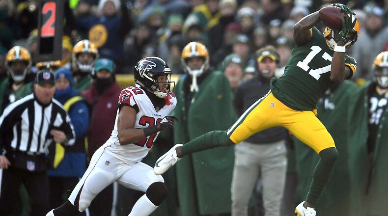 GREEN BAY, WISCONSIN - DECEMBER 09: Davante Adams #17 of the Green Bay Packers catches a pass in front of Isaiah Oliver #20 of the Atlanta Falcons during the first half of a game at Lambeau Field on December 09, 2018 in Green Bay, Wisconsin. (Photo by Stacy Revere/Getty Images)