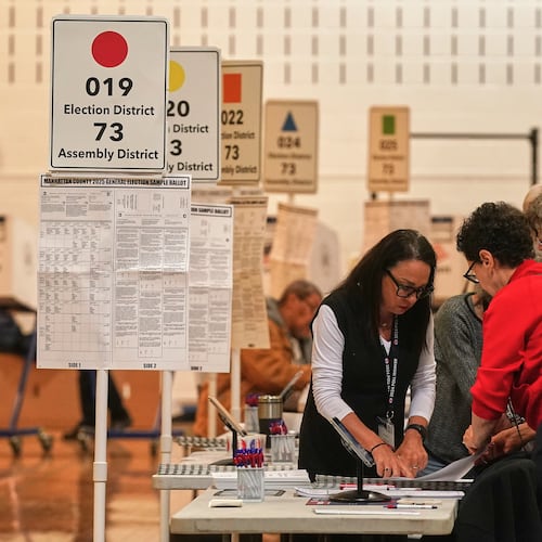 Workers prepare for voters at a poll site, in New York, Tuesday, Nov. 4, 2025. (AP Photo/Richard Drew)