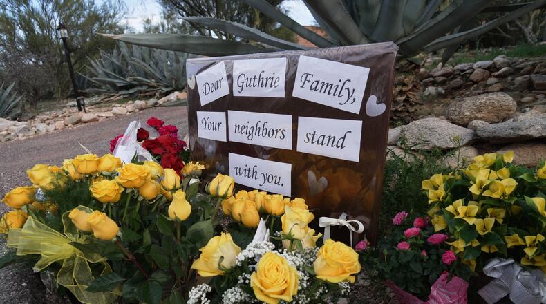 A small vigil grows near Nancy Guthrie's house, Wednesday, Feb. 11, 2026 in Tucson, Ariz. (AP Photo/Ty ONeil)