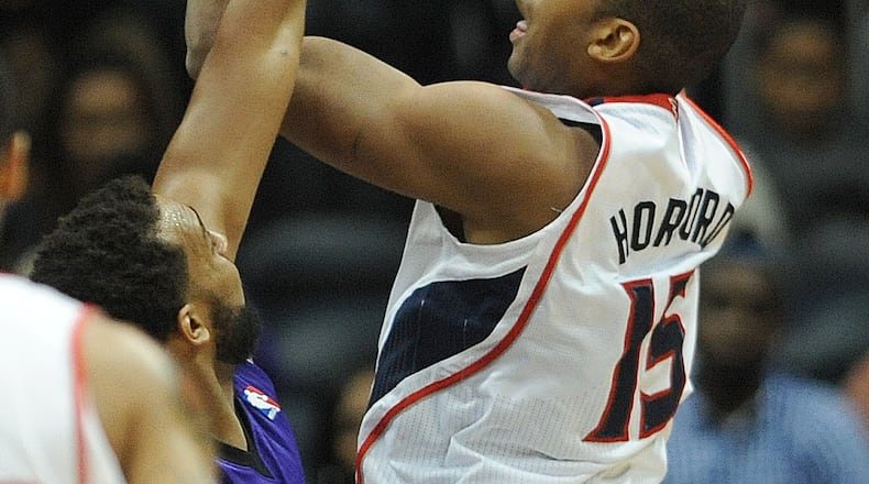 December 18, 2013 - Atlanta: Atlanta Hawks Al Horford (15) shoots the basketball over the hands of a Sacramento Kings player on Wednesday, December 18, 2013, in Philips Arena. The Hawks won the game 124 to 107 and Horford had 25 points. JOHNNY CRAWFORD / JCRAWFORD@AJC.COM Al Horford is returning from a torn right pectoral muscle that limited him to 29 games last season. (AJC File)