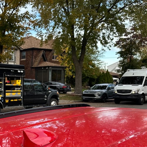 An FBI Evidence Response Team truck is seen idling in a Dearborn, Mich., neighborhood on Friday, Oct. 31, 2025. (AP Photo/Mike Householder)