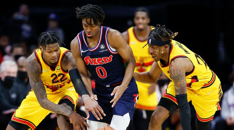 Philadelphia 76ers guard Tyrese Maxey steals the basketball against Atlanta Hawks forward Cam Reddish (left) and forward Wes Iwundu during the second quarter on Thursday, Dec. 23, 2021, at Wells Fargo Center in Philadelphia. (Yong Kim/The Philadelphia Inquirer/TNS)