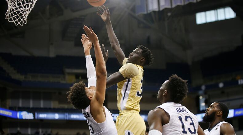 Georgia Tech forward Abdoulaye Gueye (34) goes up shot over Pittsburgh forward Kene Chukwuka (15) during the first half of an NCAA college basketball game, Saturday, Jan. 13, 2018, in Pittsburgh. (AP Photo/Jared Wickerham)