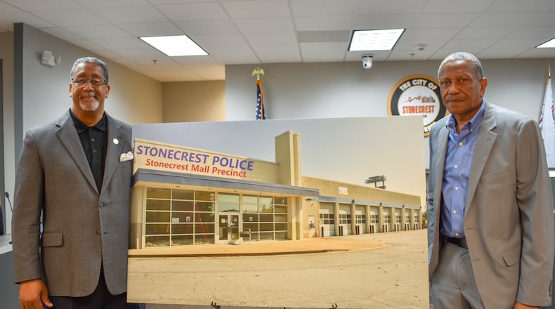 Stonecrest Mayor Jason Lary (left) and Councilman Jimmy Clanton pose with a rendering of the old Sears facility. The city looks to sell the property, putting an end to city leaders' vision of transforming it into a public safety center.