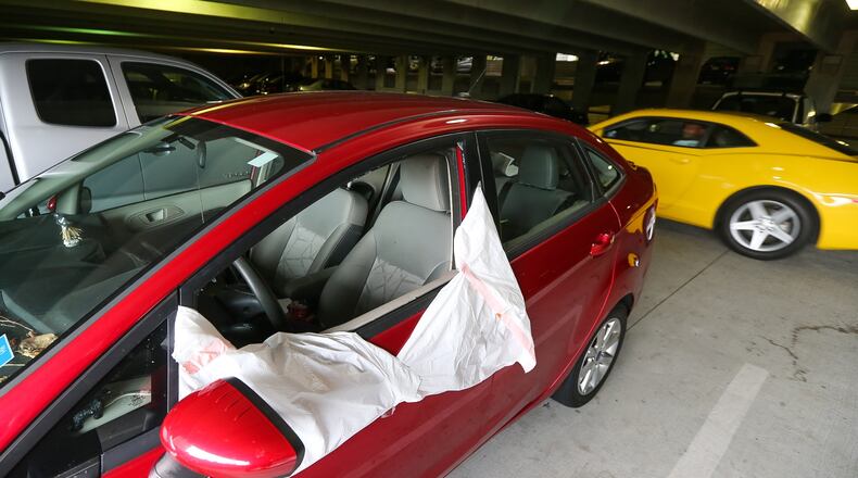 Three people were arrested Thurs., Sept. 10, 2015 — at the same Northside Drive parking deck where 14 vehicles were broken into a day earlier. JOHN SPINK / JSPINK@AJC.COM