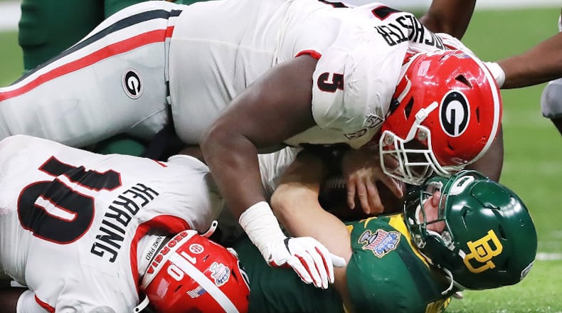 Georgia defensive lineman Julian Rochester (top) and Malik Herring level Baylor quarterback Charlie Brewer in the Sugar Bowl Wednesday, Jan. 1, 2020, at the Mercedes-Benz Superdome in New Orleans.