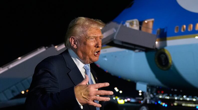 President Donald Trump speaks to reporters before boarding Air Force One at Palm Beach International Airport in West Palm Beach Fla., on his way back to the White House, Sunday, Nov. 16, 2025. (AP Photo/Manuel Balce Ceneta)