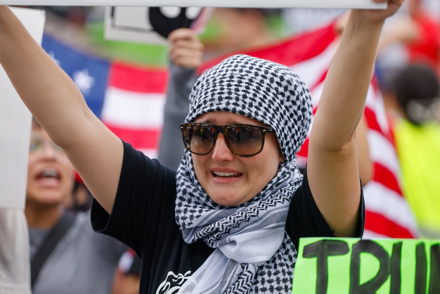 A demonstrator becomes emotional during a protest on ICE raids and deportation arrests on Chamblee Tucker Road in Atlanta on Saturday, June 14, 2025. (Arvin Temkar / AJC)