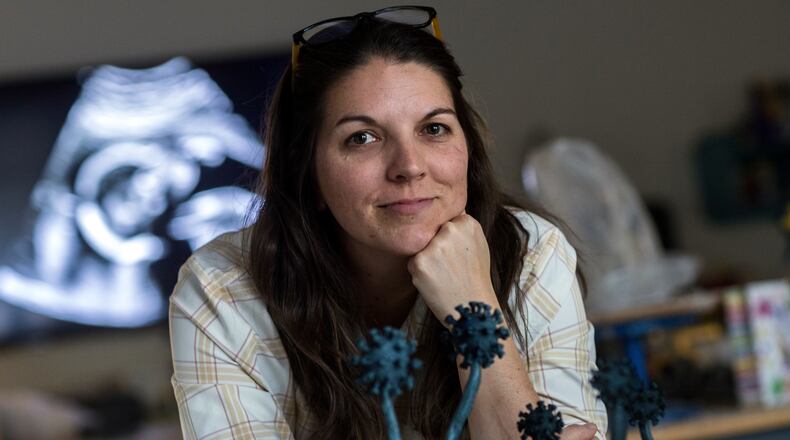 Sculptor Casey Schachner has designed a monument to COVID-19 victims around the globe. Modeled after dandelion flowers, the Savannah resident’s soaring outdoor sculpture is expected to be unveiled in Chicago by the fall of this year. In the background is an ultrasound image of her daughter, Lottie, who was born during the first year of the pandemic. (Stephen B. Morton for the AJC)