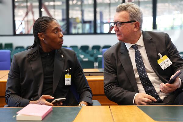 South Africa's Caster Semenya speaks to lawyer Gregory Nott, right, in the European Court of Human Rights before a decision over sex eligibility rules in sports, Thursday, July 10, 2025 in Strasbourg, eastern France. (AP Photo/Antonin Utz)
