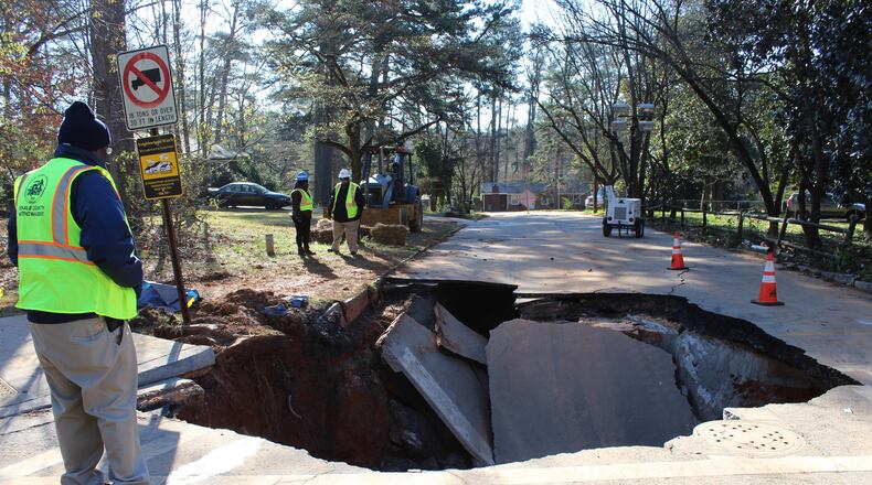 Crews were at work after a water-main break left a large hole in Beech Drive in DeKalb County. (Credit: DeKalb County Watershed Management)