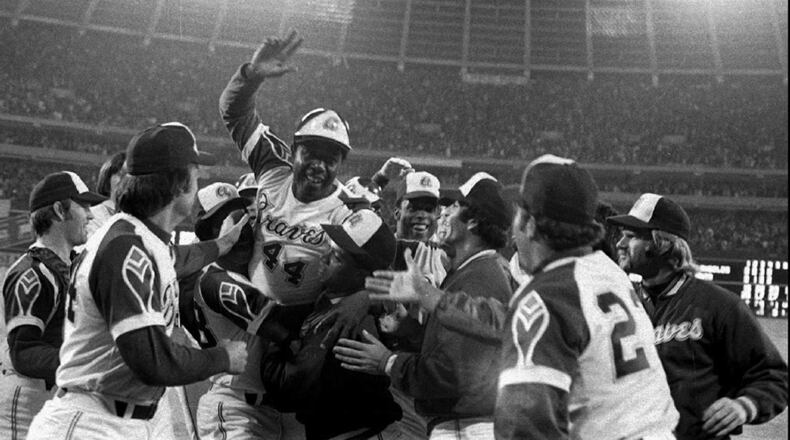 Braves slugger Hank Aaron is welcomed at home plate after smashing his 715th career home run - breaking Babe Ruth's record on April 8, 1974, at Atlanta-Fulton County Stadium. (AP Photo/File)