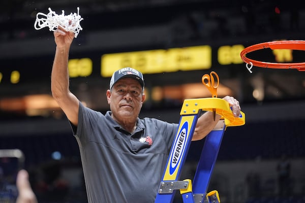 Houston head coach Kelvin Sampson celebrates while cutting down the net following his team's victory over Tennessee in the Elite Eight round of the NCAA college basketball tournament Sunday, March 30, 2025, in Indianapolis. (AP Photo/Michael Conroy)