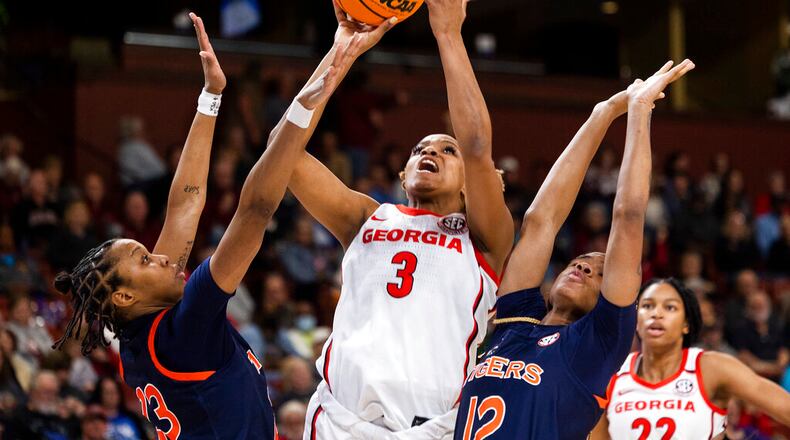 Georgia's Diamond Battles (3) shoots against Auburn's Honesty Scott-Grayson (23) and Mar'shaun Bostic (12) in the first half of an NCAA college basketball game in the Southeastern Conference women's tournament in Greenville, S.C., Thursday, March 2, 2023. (AP Photo/Mic Smith)