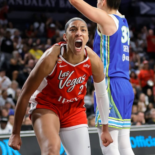 Las Vegas Aces center A'ja Wilson, left, reacts after scoring against Dallas Wings forward Jessica Shepard, right, during the first half of a WNBA basketball game Thursday, June 25, 2026, in Las Vegas. (Steve Marcus/Las Vegas Sun via AP)