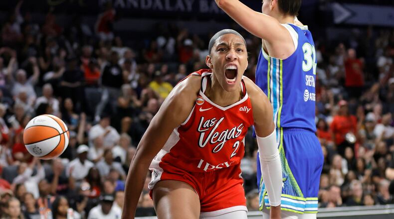 Las Vegas Aces center A'ja Wilson, left, reacts after scoring against Dallas Wings forward Jessica Shepard, right, during the first half of a WNBA basketball game Thursday, June 25, 2026, in Las Vegas. (Steve Marcus/Las Vegas Sun via AP)
