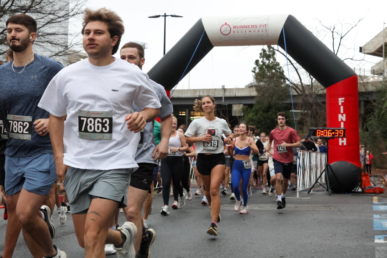Runners come out of the gate on Saturday, Feb. 21, 2026, at a 5K walk/run and memorial service at UGA for Augusta University nursing student Laken Riley. Riley was attacked on Feb. 22, 2024 while running in Oconee Forest Park on the UGA campus and killed. Riley had previously attended UGA and was an avid runner. (C.J. Bartunek for the AJC)

