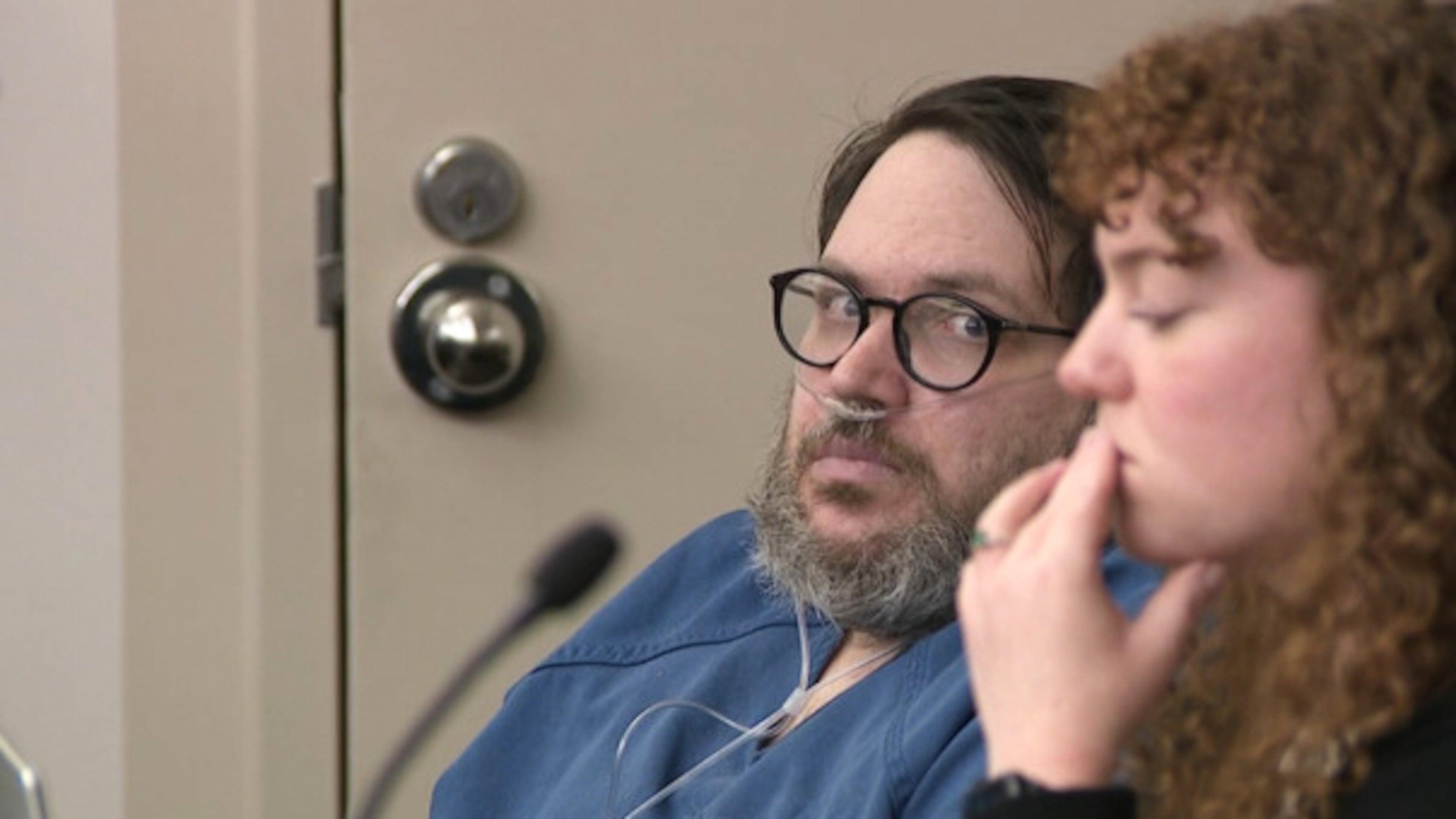 In this image captured from video, Nicholas Rossi, left, appears in a Salt Lake City court, Monday, Oct. 20, 2025, for his sentencing hearing on a rape conviction. To his right is MacKenzie Potter of the Salt Lake Legal Defender Association. (Fox 13/Pool Video via AP)
