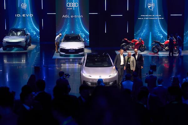 Volkswagen executives and guest pose for photos during the Volkswagen Group media night ahead of the Auto Show in Shanghai, Tuesday, April 22, 2025. (AP Photo/Ng Han Guan)
