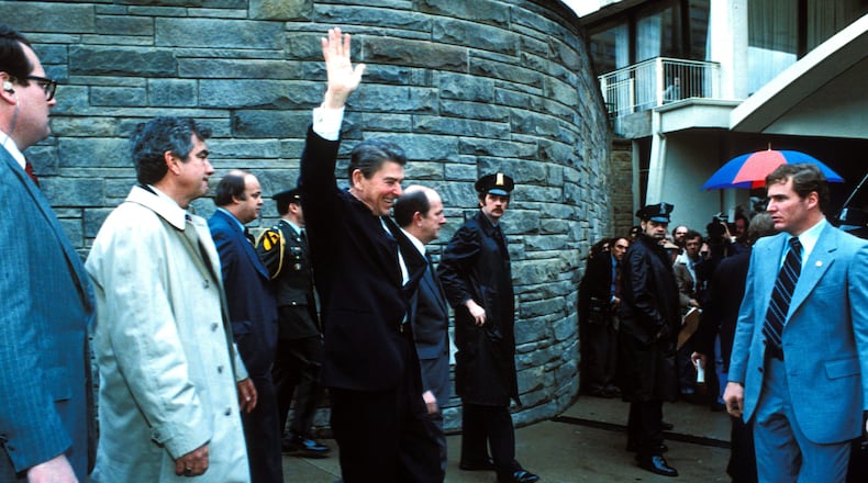 Secret Service and onlookers at the Washington Hilton Hotel, just moments before would-be assassin John Hinckley fired his pistol at President Ronald Reagan on March 30, 1981. Also wounded in the attack were White House press secretary James Brady (balding gentleman standing behind the president), Patrolman Thomas Delahanty and Secret Service Agent Timothy McCarthy.