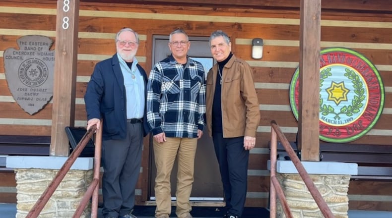 Robert Wilson, left, and Clifton Chippewa, right, stand with Michell Hicks, the principal chief of the Eastern Band of Cherokee Indians.