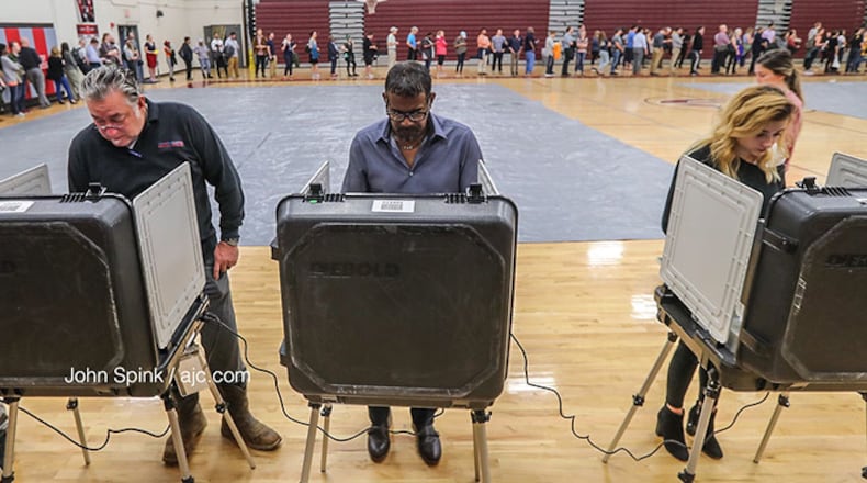 Voters cast their ballots at Grady High School on Tuesday. (John Spink/AJC )
