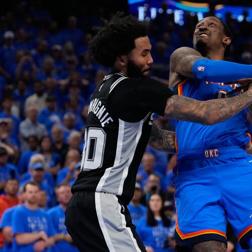 San Antonio Spurs forward Julian Champagnie (30) defends against Oklahoma City Thunder guard Jalen Williams (8) during overtime of Game 1 in a third-round NBA basketball playoffs series Monday, May 18, 2026, in Oklahoma City. (AP Photo/Tony Gutierrez)