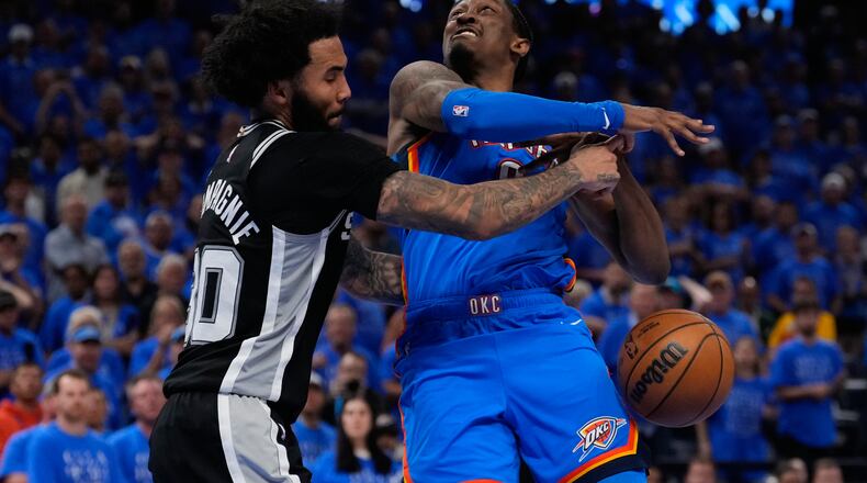 San Antonio Spurs forward Julian Champagnie (30) defends against Oklahoma City Thunder guard Jalen Williams (8) during overtime of Game 1 in a third-round NBA basketball playoffs series Monday, May 18, 2026, in Oklahoma City. (AP Photo/Tony Gutierrez)
