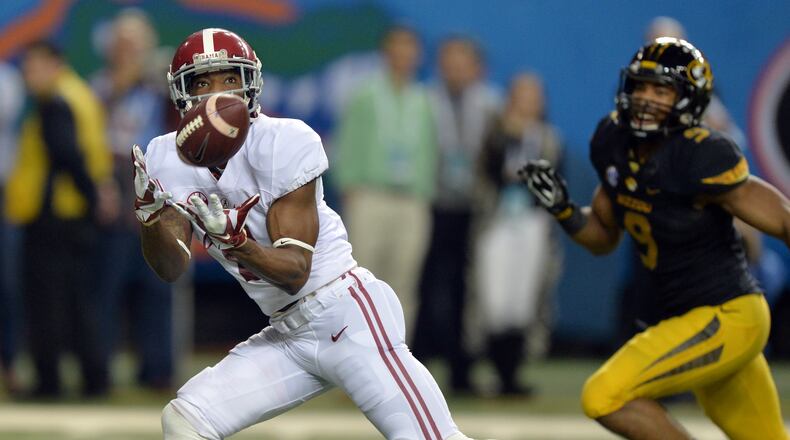 December 6, 2014 Atlanta: Alabama Crimson Tide wide receiver DeAndrew White hauls in a touchdown pass in front of Missouri Tigers safety Braylon Webb during the first half of the 2014 SEC Championship at the Georgia Dome Saturday December 6, 2014. BRANT SANDERLIN / BSANDERLIN@AJC.COM Alabama receiver DeAndrew White caught this 58-yard touchdown pass from Blake Sims in the first half. (Brant Sanderlin, AJC)