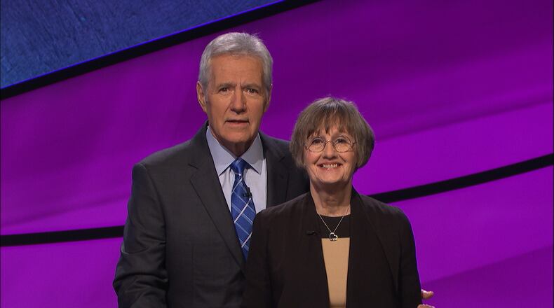 Claudia Stucke, a former writer and high school English teacher from Decatur, with “Jeopardy!” host Alex Trebek competes in “Jeopardy!” tonight. CONTRIBUTED