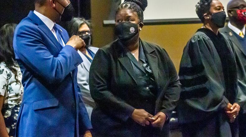 Atlanta Mayor Andre Dickens, left, talks with Atlanta Public Schools Superintendent Lisa Herring before the swearing-in ceremony for the Atlanta Board of Education members in January.  STEVE SCHAEFER/AJC FILE PHOTO