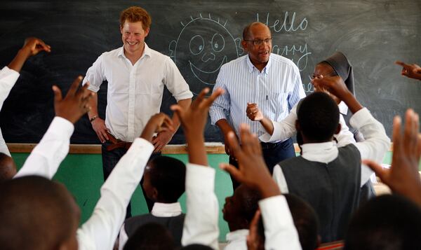 FILE - Britain's Prince Harry, left, accompanied by Prince Seeiso of Lesetho, meets pupils in a class during his visit to the Kananelo Centre for the Deaf outside Maseru, Lesotho, Wednesday, Feb. 27, 2013. (AP Photo/Themba Hadebe, File)