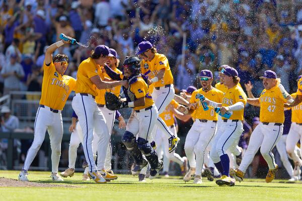 LSU players celebrate the defeating Coastal Carolina in Game 2 of the NCAA College World Series baseball finals in Omaha, Neb., Sunday, June 22, 2025. (AP Photo/Rebecca S. Gratz)