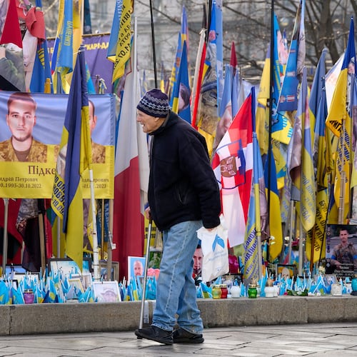 A man walks around an improvised memorial to fallen soldiers killed in the Russia-Ukraine war at Independence square in Kyiv, Ukraine, Wednesday, Dec. 10, 2025. (AP Photo/Efrem Lukatsky)