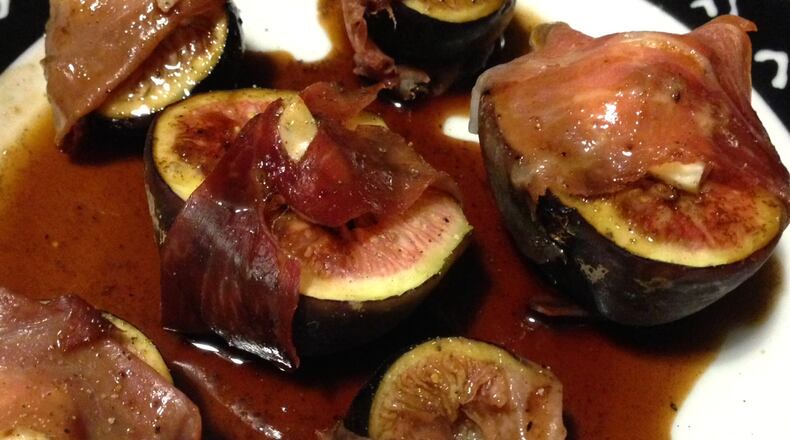 Create a ‘well’ in the middle of the fig halves with your finger and fill them with blue cheese. Then wrap proscuitto around the fig halves. While they’re baking, make a simple sauce with balsamic vinegar, honey and pepper. Your dinner guests will swoon over the result. (Staff photo by Connie Post)