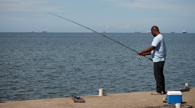 A man fishes in Cocorite, Trinidad and Tobago, Friday, Oct. 3, 2025. (AP Photo/Anselm Gibbs)