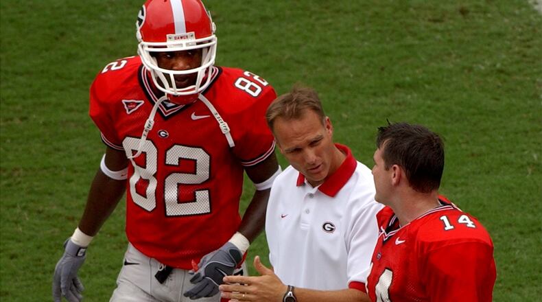 Former Georgia wide receiver Fred Gibson, shown here with coach Mark Richt and quarterback David Greene in a 2002 game, returned to UGA and graduated. (BRANT SANDERLIN/AJC staff)