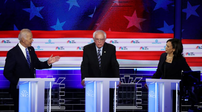 U.S. Sen. Kamala Harris of California (right) and former Vice President Joe Biden (left) speak over Sen. Bernie Sanders of Vermont during the second night of the first Democratic presidential debate in Miami on Thursday. Drew Angerer/Getty Images
