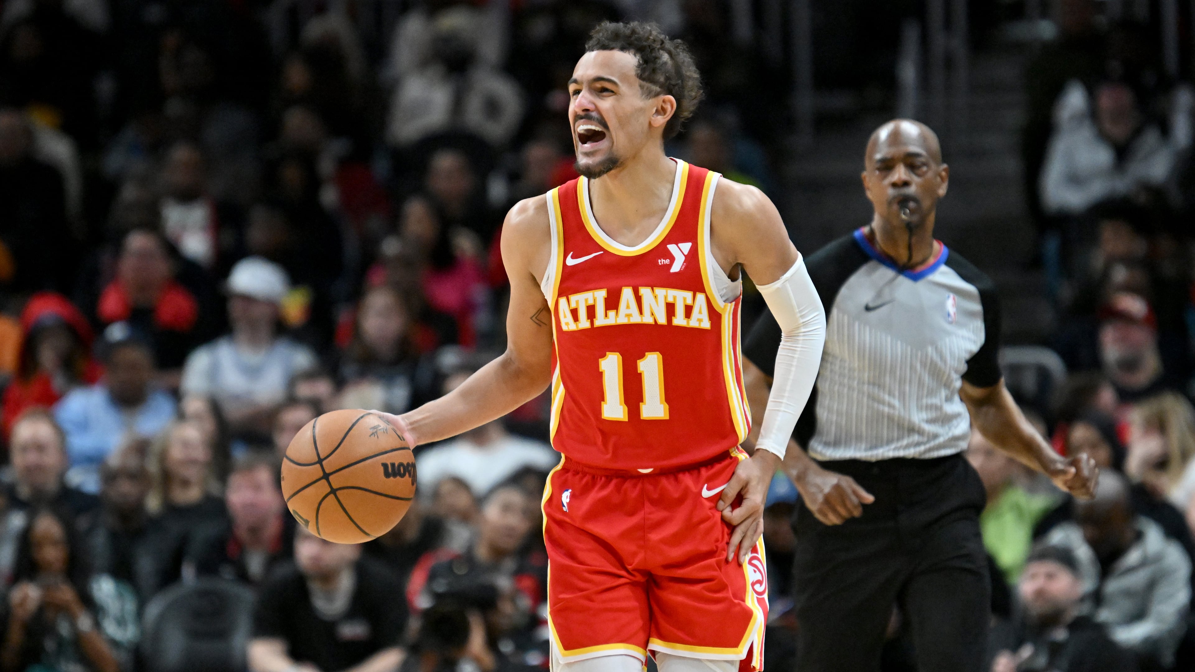 Atlanta Hawks guard Trae Young shouts instructions as he brings the ball upcourt during the second half in an NBA basketball game at State Farm Arena, Saturday, February 10, 2024, in Atlanta. (Hyosub Shin/AJC)