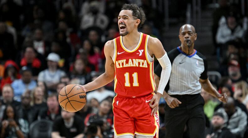 Atlanta Hawks guard Trae Young (11) shouts instructions as he brings the ball upcourt during the second half in an NBA basketball game at State Farm Arena, Saturday, February 10, 2024, in Atlanta. Atlanta Hawks won 122 - 113 over Houston Rockets. (Hyosub Shin / Hyosub.Shin@ajc.com)