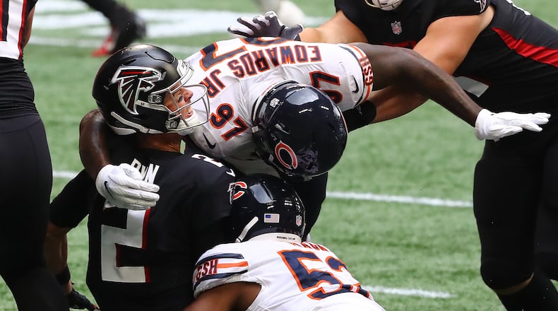 Falcons quarterback Matt Ryan is sacked and stripped of the ball by Chicago Bears linebacker Khalil Mack as he is leveled by Mario Edwards, who was called for unnecessary roughness, for what looked to be a turnover during the second quarter Sunday, Sept. 27, 2020, in Atlanta. The Bears had 2 penalties on the play negating the turnover.   (Curtis Compton / Curtis.Compton@ajc.com)