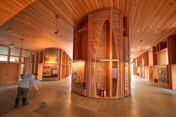 A national park employee sweeps the floor in the Tekakapimək Contact Station, Jan. 7, 2025, at the Katahdin Woods and Waters Monument in northern Maine. (AP Photo/Robert F. Bukaty)