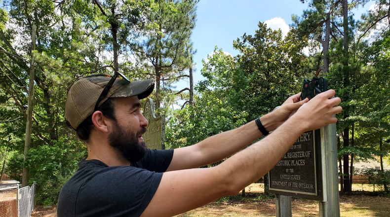 Rory Hawkins, also known as Catlanta, "drops" a kitten at Utoy Cemetery.