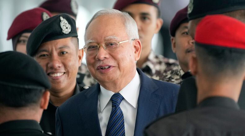 FILE - Former Malaysian Prime Minister Najib Razak arrives at the Kuala Lumpur High Court complex escorted by prison officers in Kuala Lumpur, Malaysia, on April 4, 2024. (AP Photo/Vincent Thian, File)