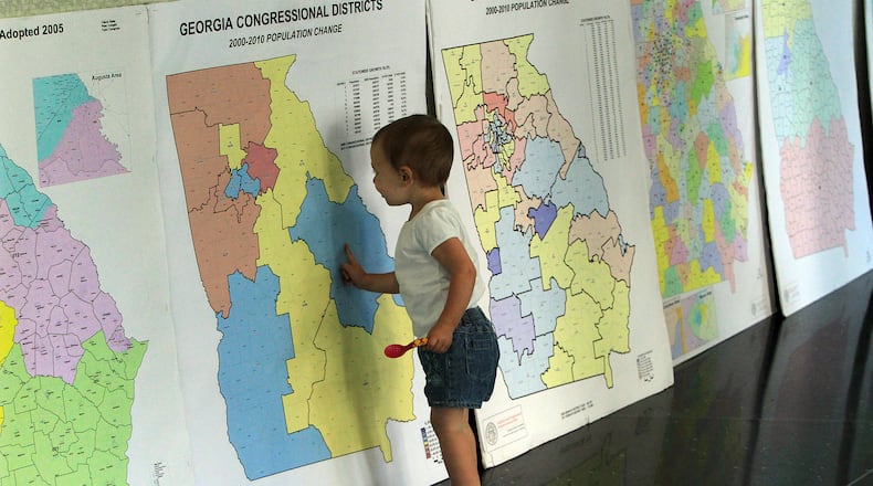 A child looks over redistricting maps during a 2011 public hearing.