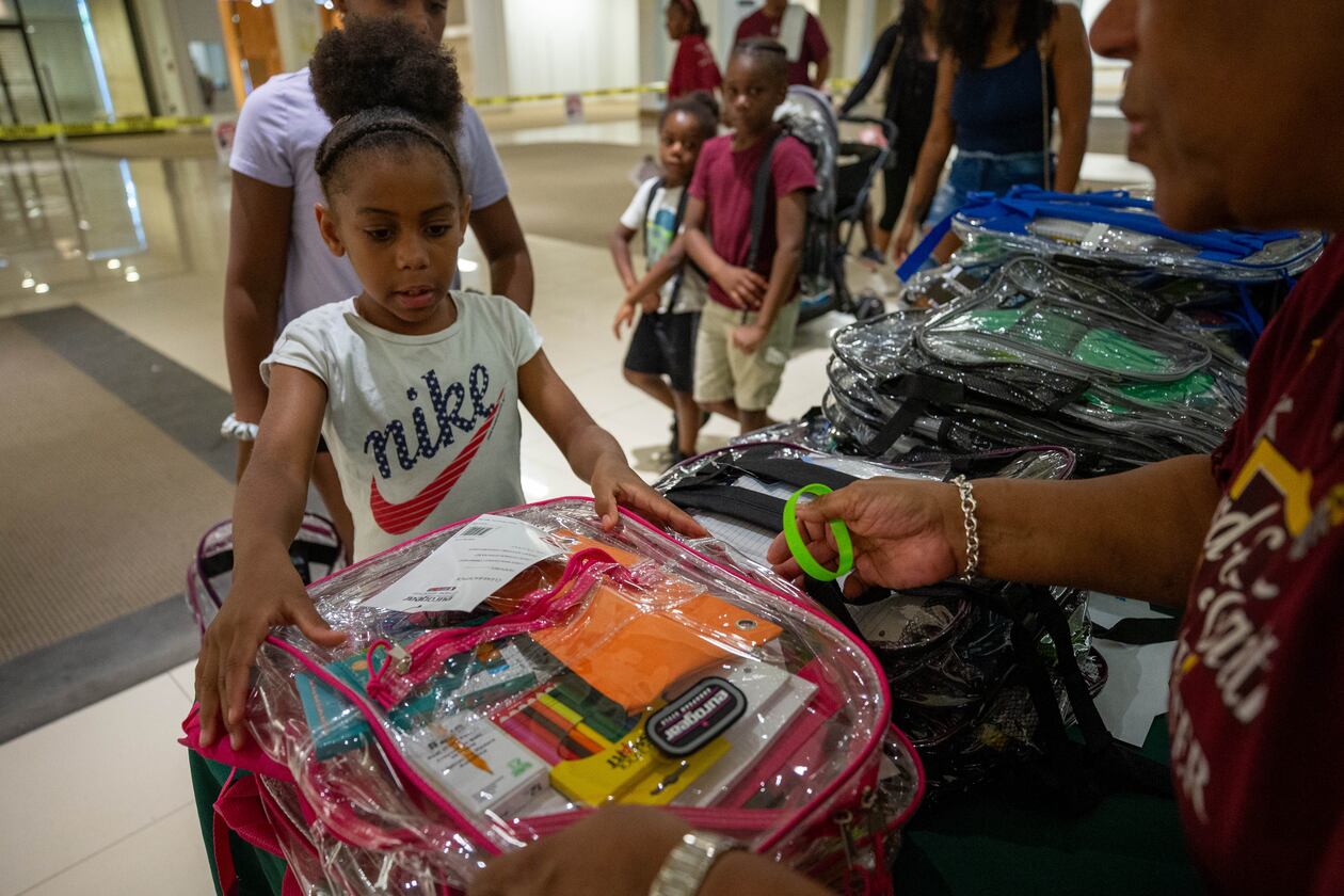 Makayla Smith receives a free school supply kit and clear backpack at the 20th annual Back-to-School Bash at Greenbriar Mall in Atlanta on Saturday, July 22, 2023. (Katelyn Myrick/AJC)